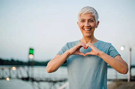 woman holding hands in a heart shape